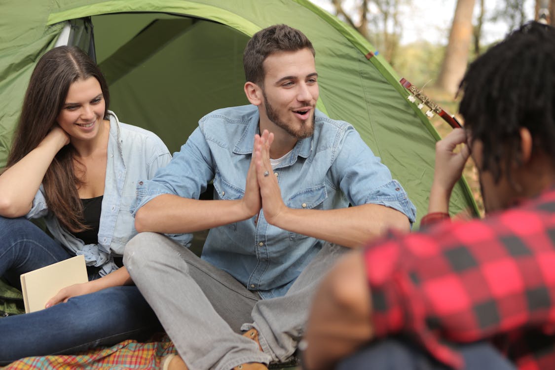 Cheerful friends having fun in camp