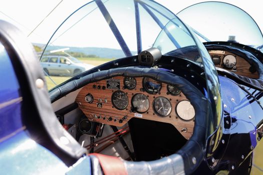 Close-up of a vintage airplane cockpit showcasing detailed gauges and controls, perfect for aviation themes.