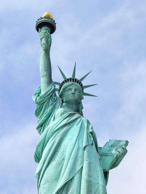 Free Close-up view of the Statue of Liberty against a bright blue sky in New York City. Stock Photo