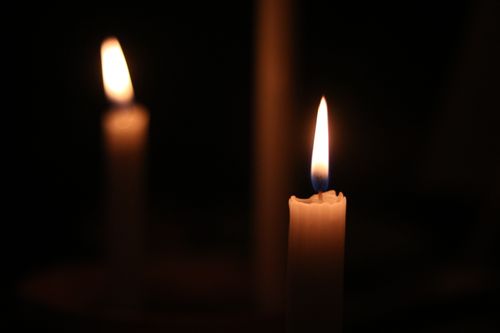 Free Soft candle flames illuminate the darkness, creating a peaceful atmosphere. Stock Photo