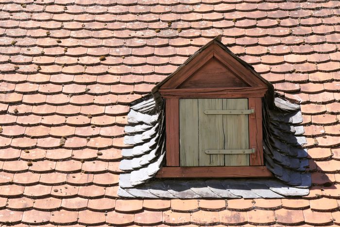 Timber dormer window on a terracotta tiled roof