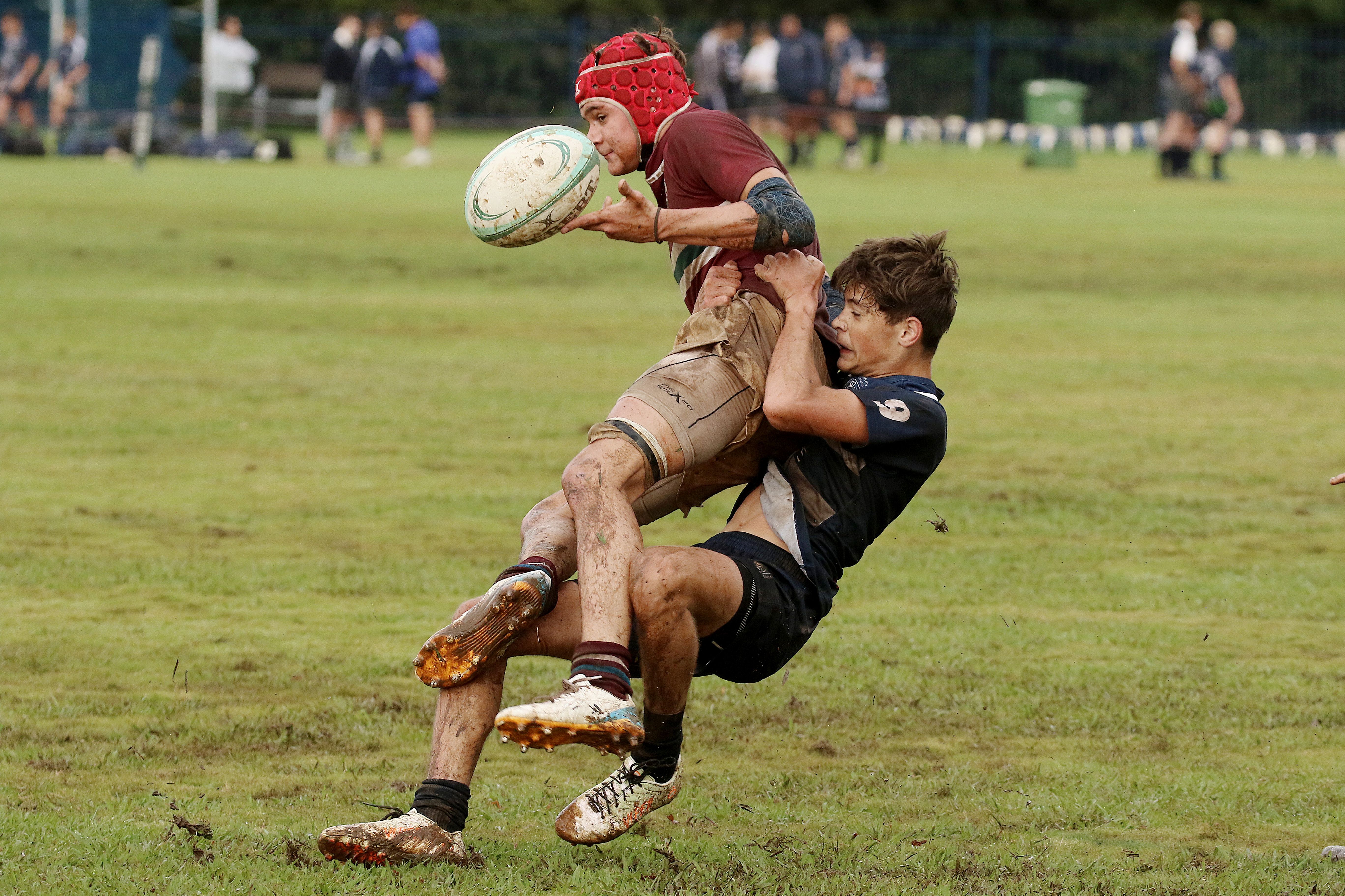 Intense Rugby Tackle on Muddy Field · Free Stock Photo