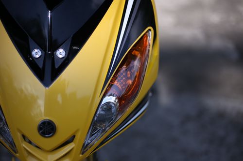Free Detailed view of a yellow and black motorcycle front with headlight. Stock Photo
