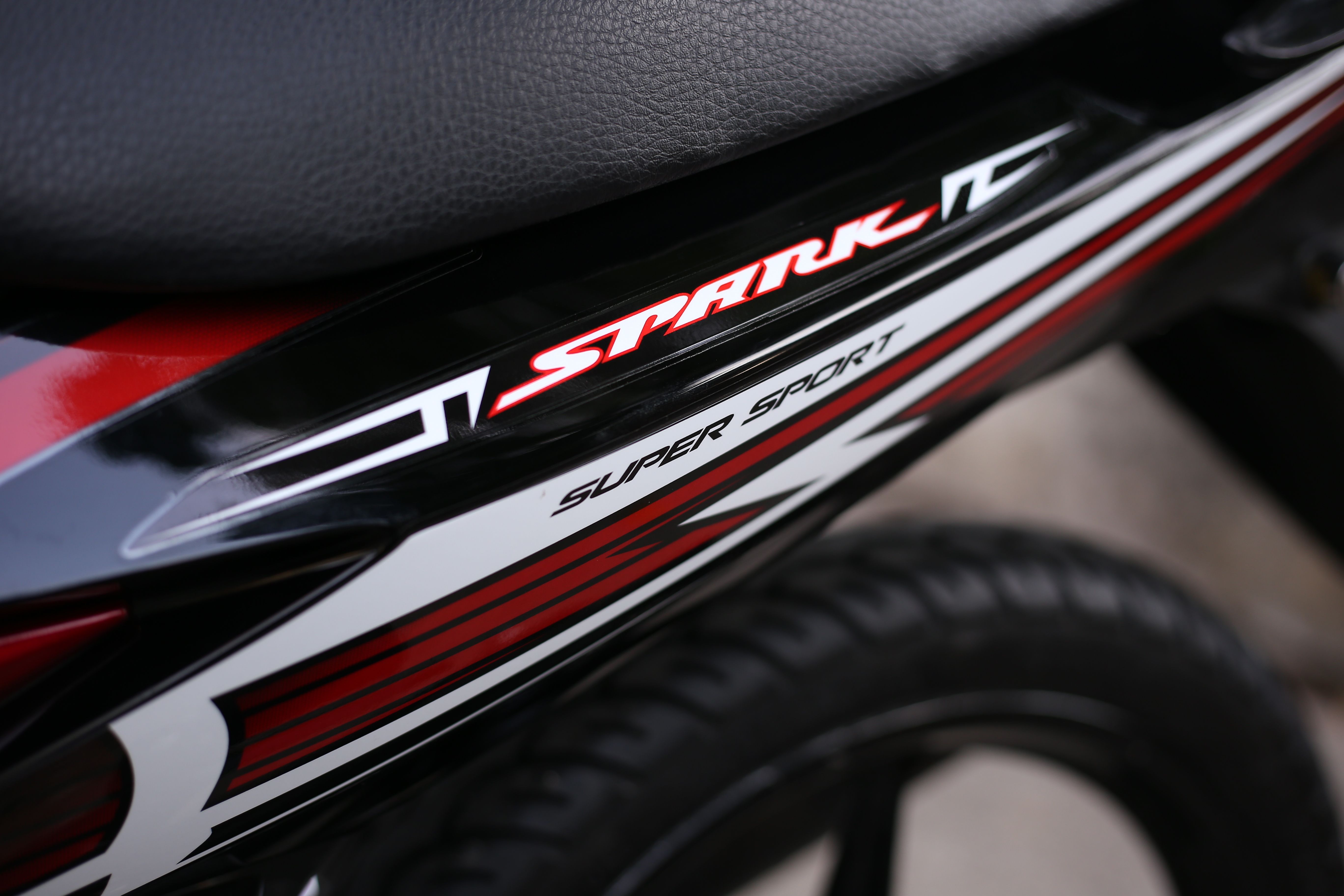 Detailed view of a Spark Super Sport motorcycle with sleek design elements and branding.