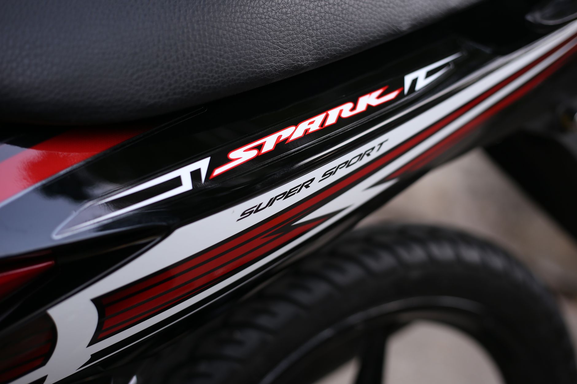 Detailed view of a Spark Super Sport motorcycle with sleek design elements and branding.