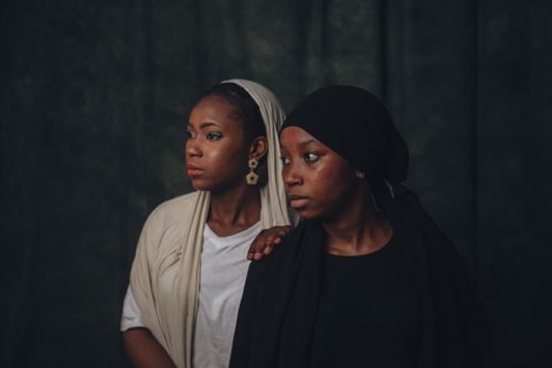 Free A captivating portrait of two Nigerian women in traditional attire, representing cultural elegance. Stock Photo