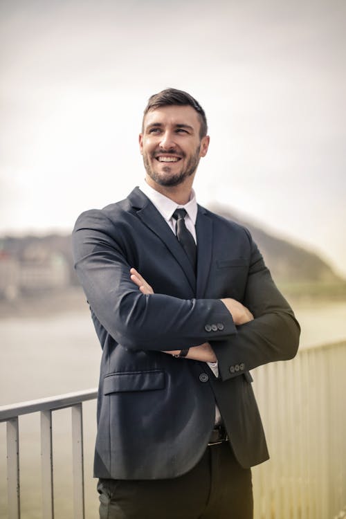 Free Man in Black Suit Jacket Standing and Smiling Stock Photo