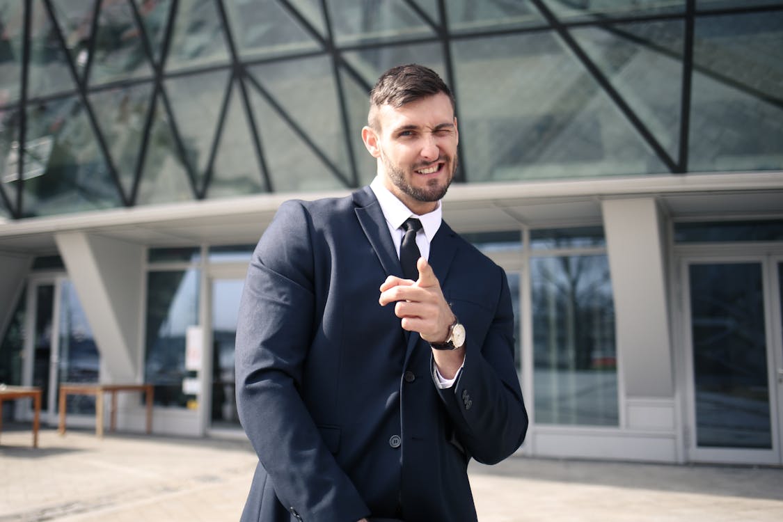 Man in Black Suit Jacket While Winking