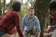 Happy friends spending time in forest