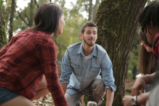 Happy friends spending time in forest