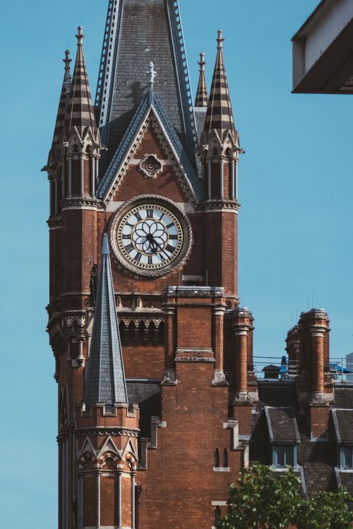 Free Close-up of the iconic clock tower at St Pancras Station in London, showcasing Victorian Gothic architecture. Stock Photo