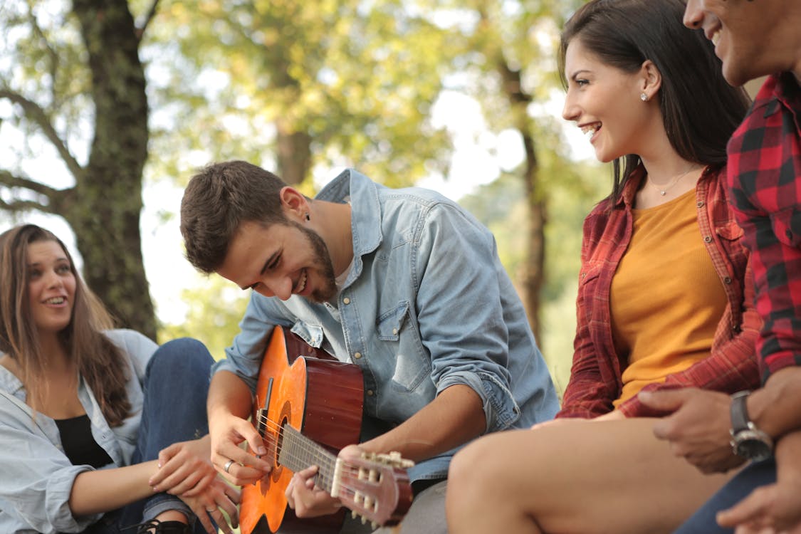 Friends spending time together with guitar