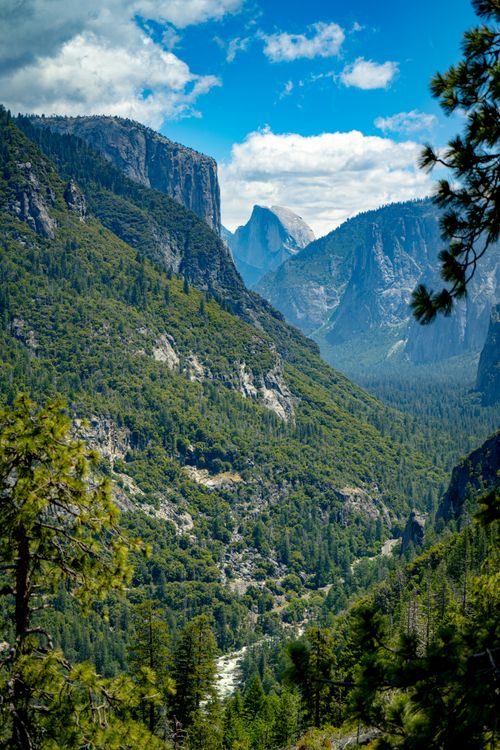 Free Breathtaking view of Yosemite Valley with iconic Half Dome under a vibrant blue sky. Stock Photo