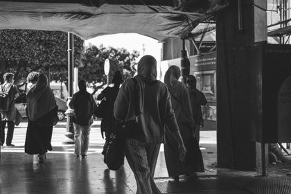 Black-and-white photograph of people walking an urban street — photo by MAG Photography on Pexels