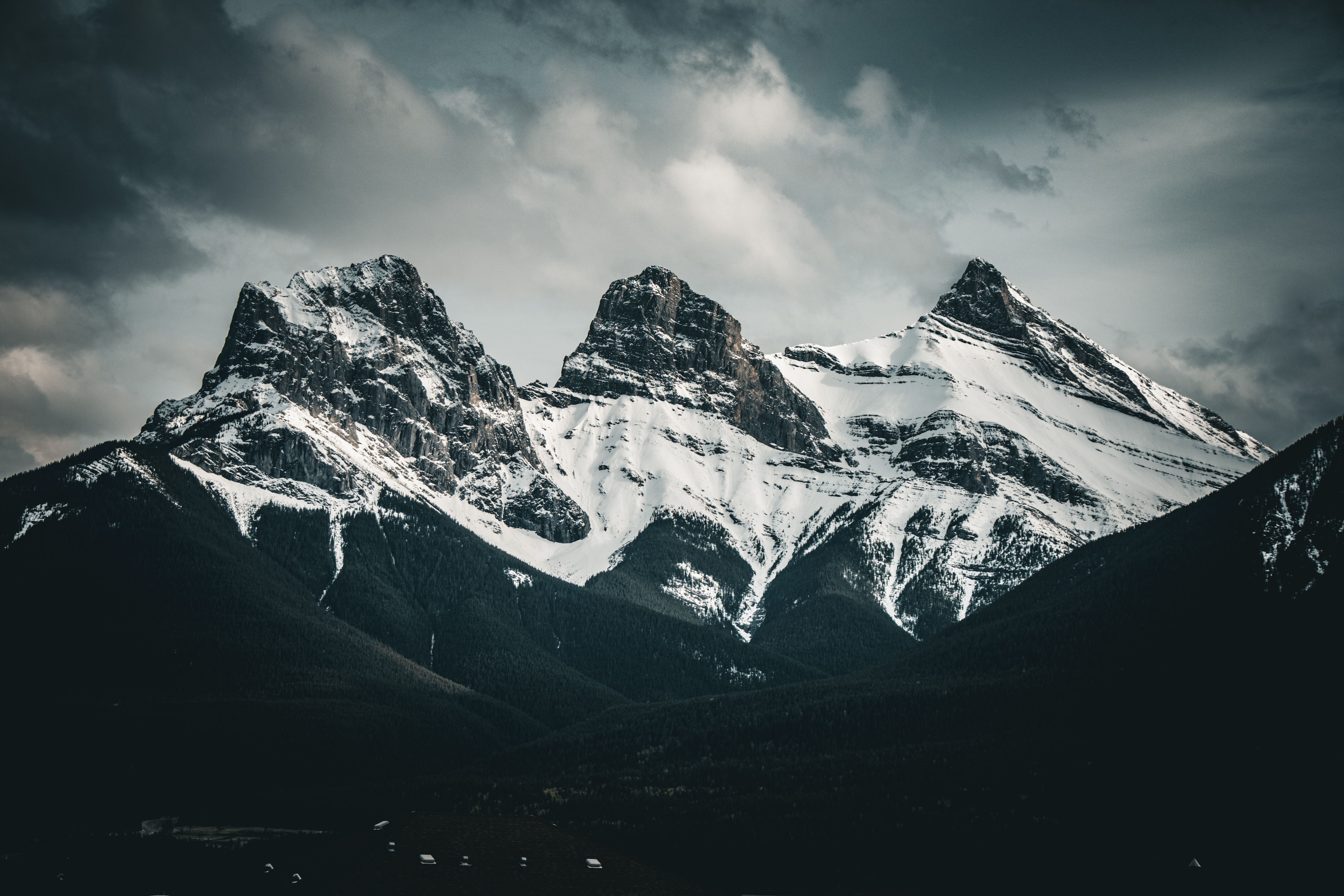 Rocky Mountain peaks under a dark Alberta sky at dusk