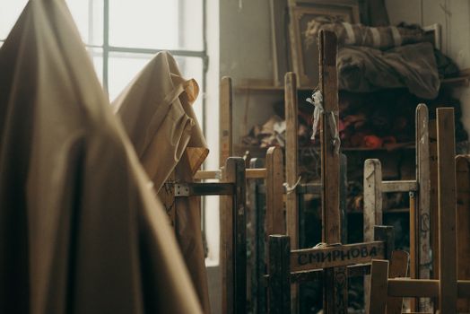 A warm and artistic space featuring wooden easels and cloths, perfect for creative expressions.