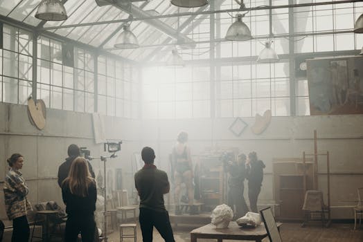 A photoshoot session capturing artistic creativity in an industrial studio with natural light.