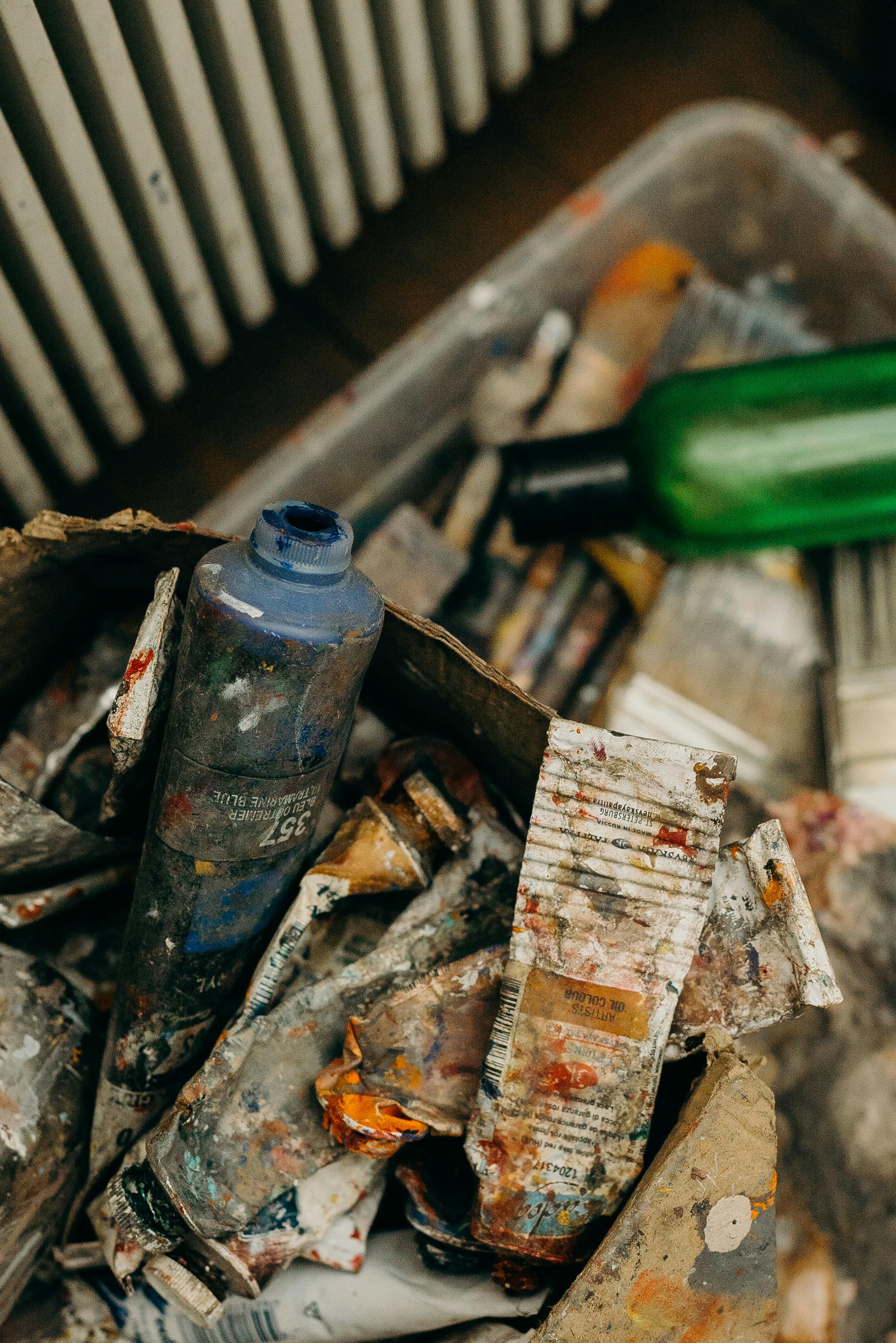 blue and green plastic bottle on top of tube containers