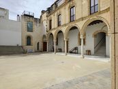 Charming stone archways in El Puerto de Santa María's historic courtyard.