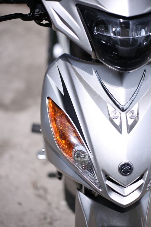 Free Detail view of a stylish silver motorcycle headlight and front panel, showcasing sleek design. Stock Photo