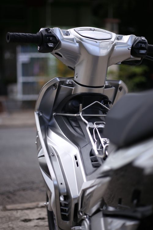 Free Modern silver scooter captured in detail from a low angle outdoors. Stock Photo