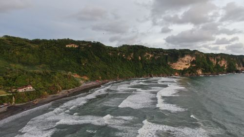 Free Discover the breathtaking coastal cliffs and waves of Yogyakarta, Indonesia, captured at dusk. Stock Photo