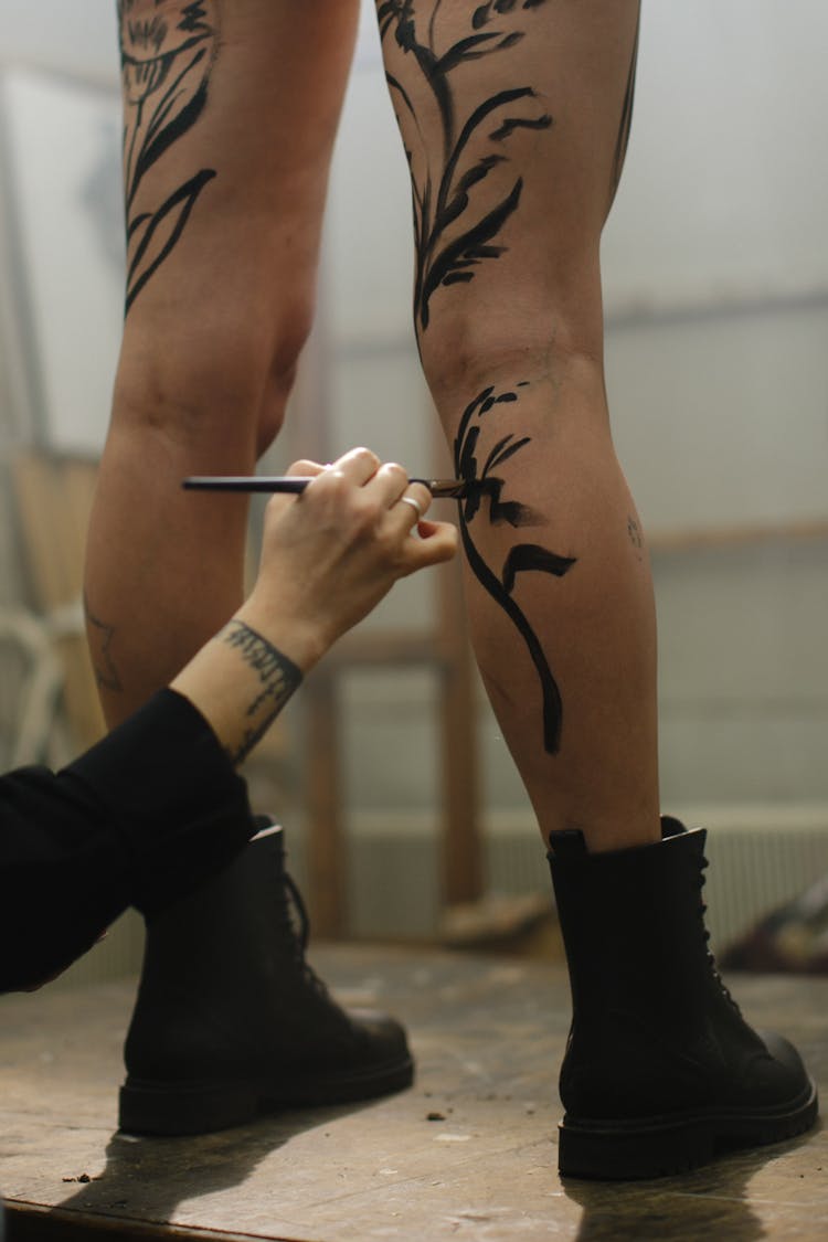 Artist Painting On Person Legs