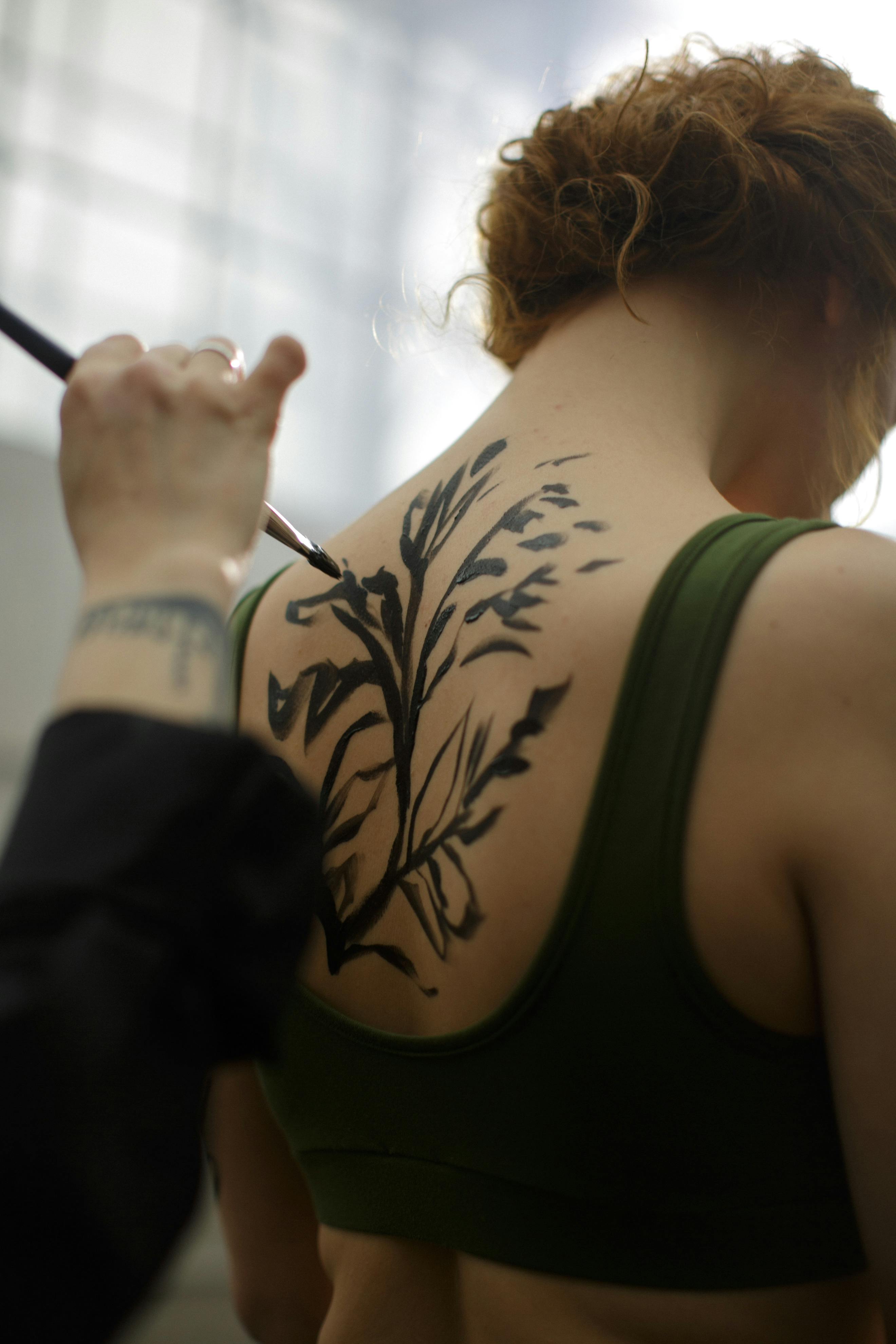 Painter Painting on Woman'Back · Free Stock Photo