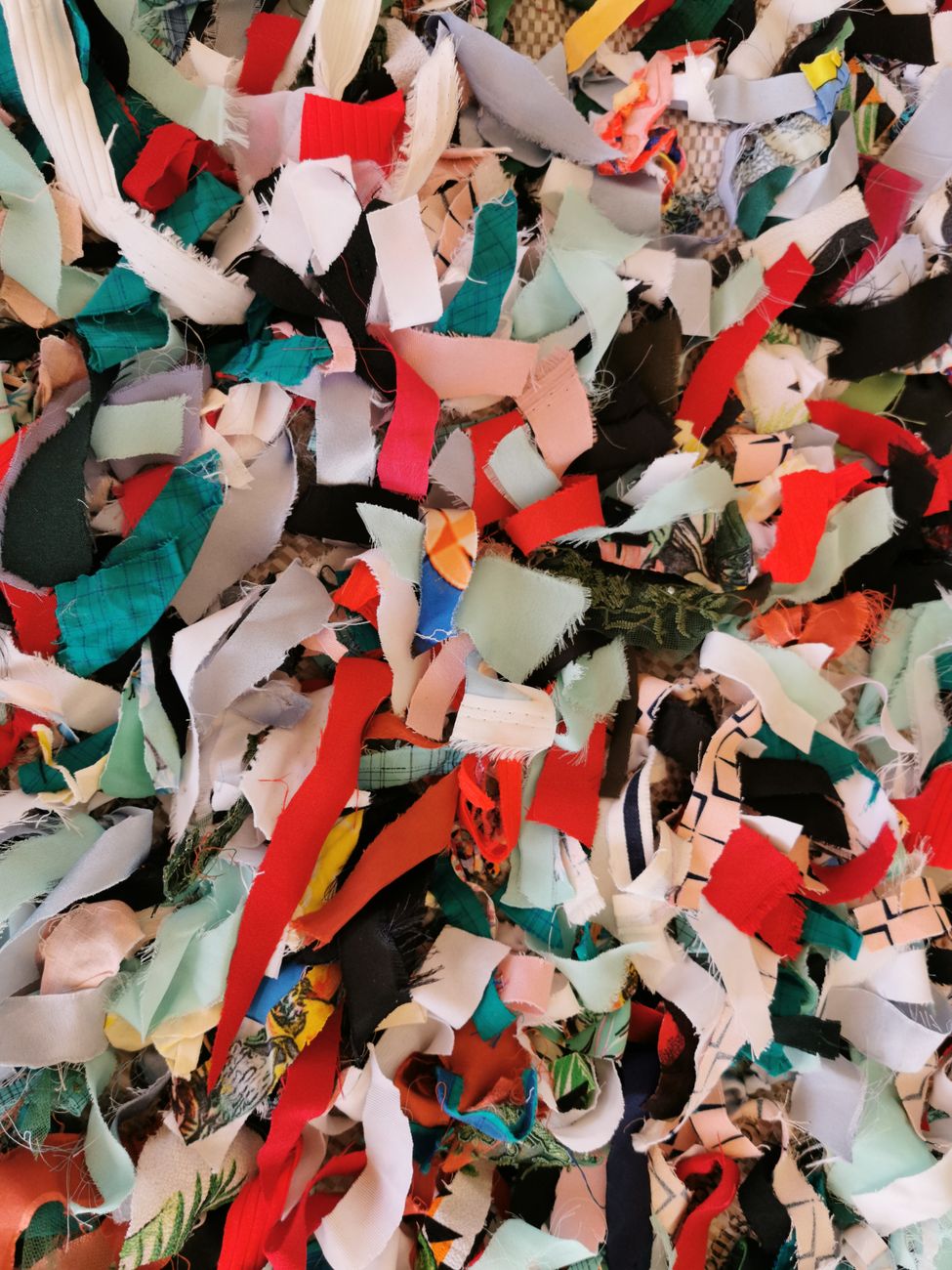 Dense bands of textile offcuts and compressed scraps, close to the material language Gogos keeps returning to