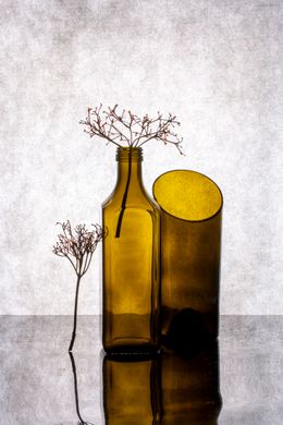 Olive glass bottle beside a tumbler, photo by Valentin Ivantsov on Pexels