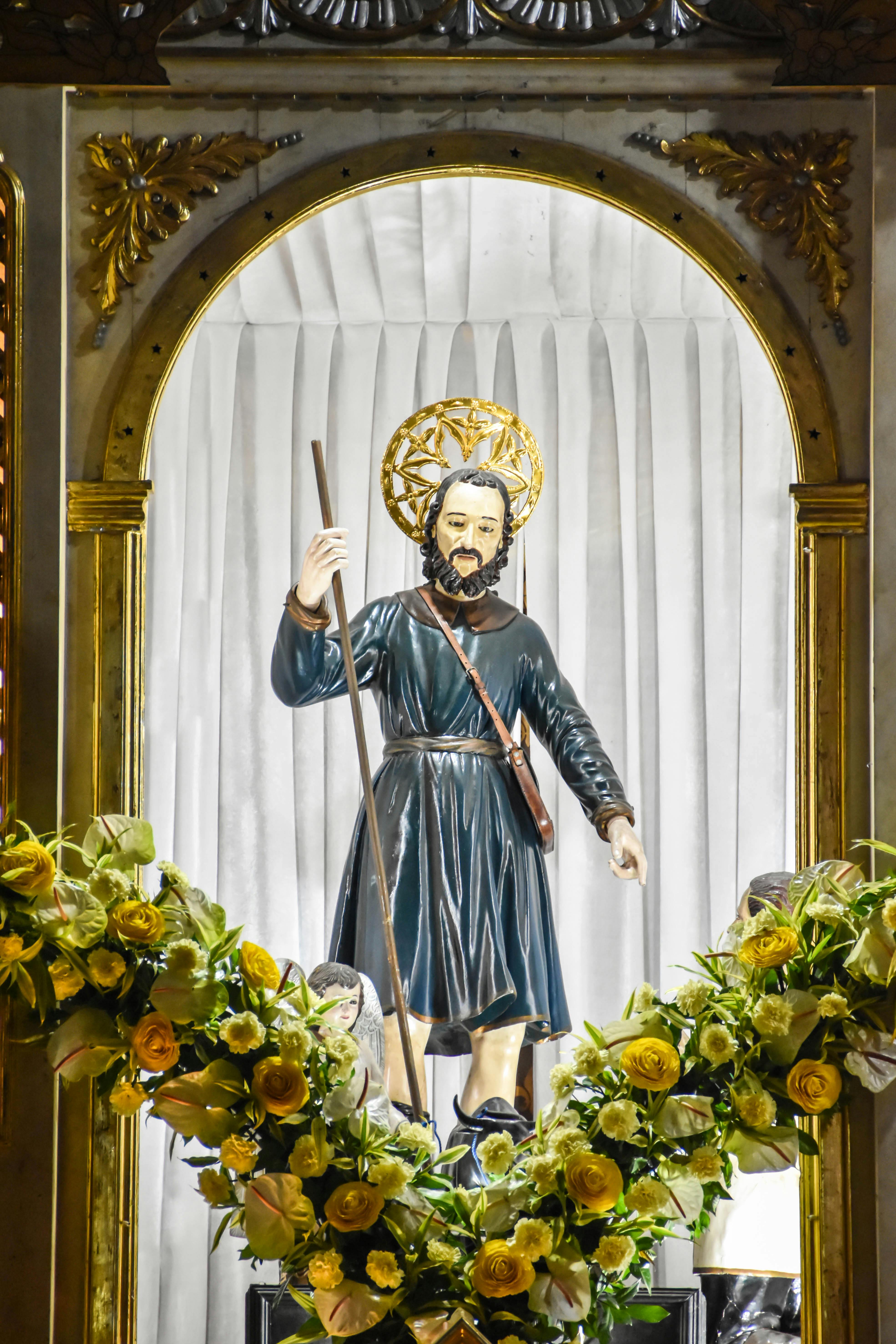 Beautiful depiction of San Isidro Labrador inside church in Pulilan, Central Luzon, decorated with yellow and white flowers.