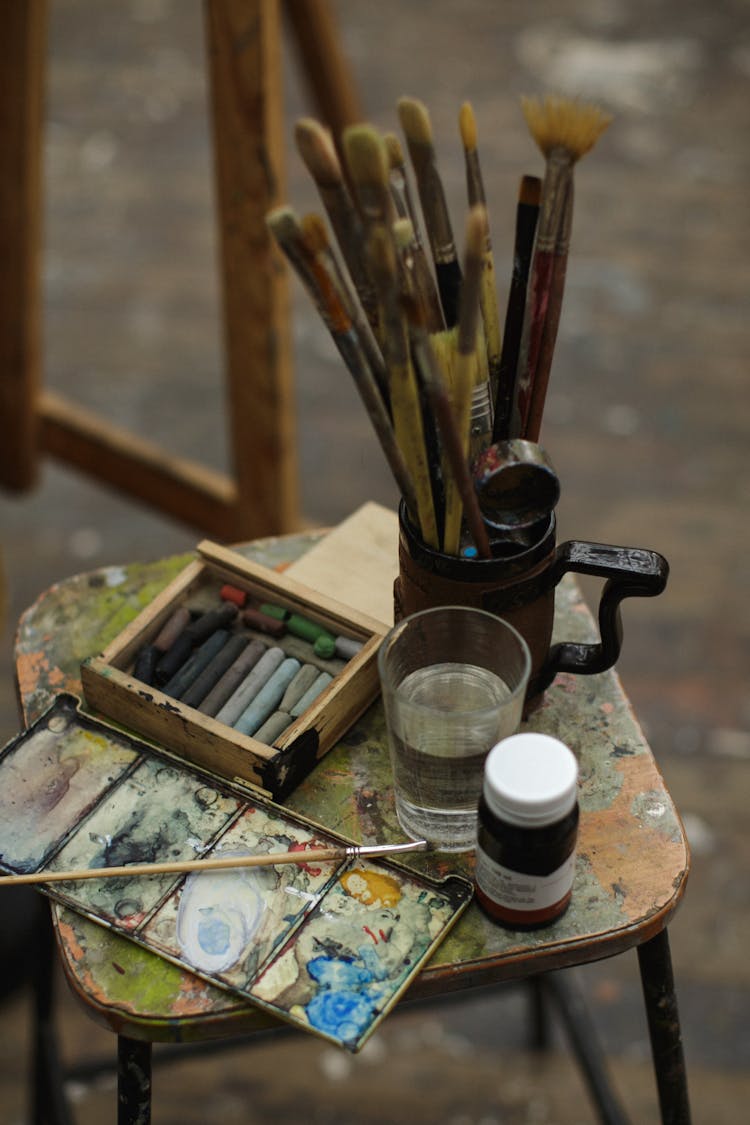 Paint Brushes Beside Glass Of Water