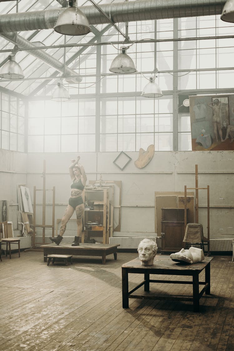 Woman Standing Inside Workshop Building