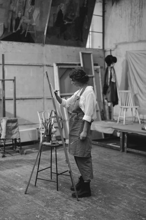 Woman in White Long sleeve Holding a Paint Brush