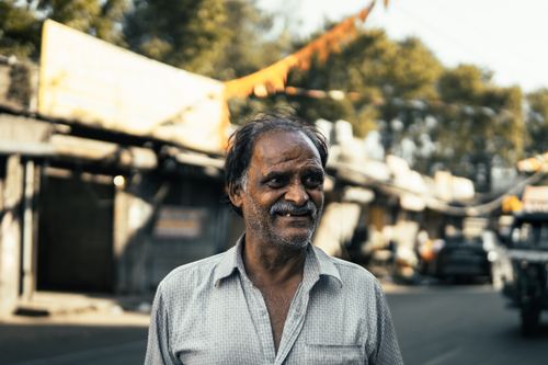 Free A cheerful man enjoys the day on a bustling street in Ludhiana, Punjab, India. Stock Photo