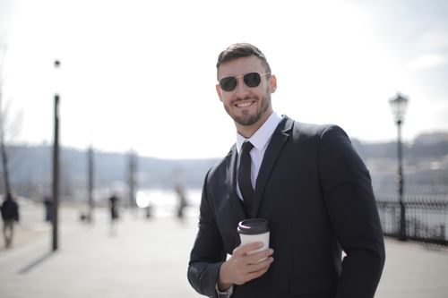 Team member holding a coffee cup