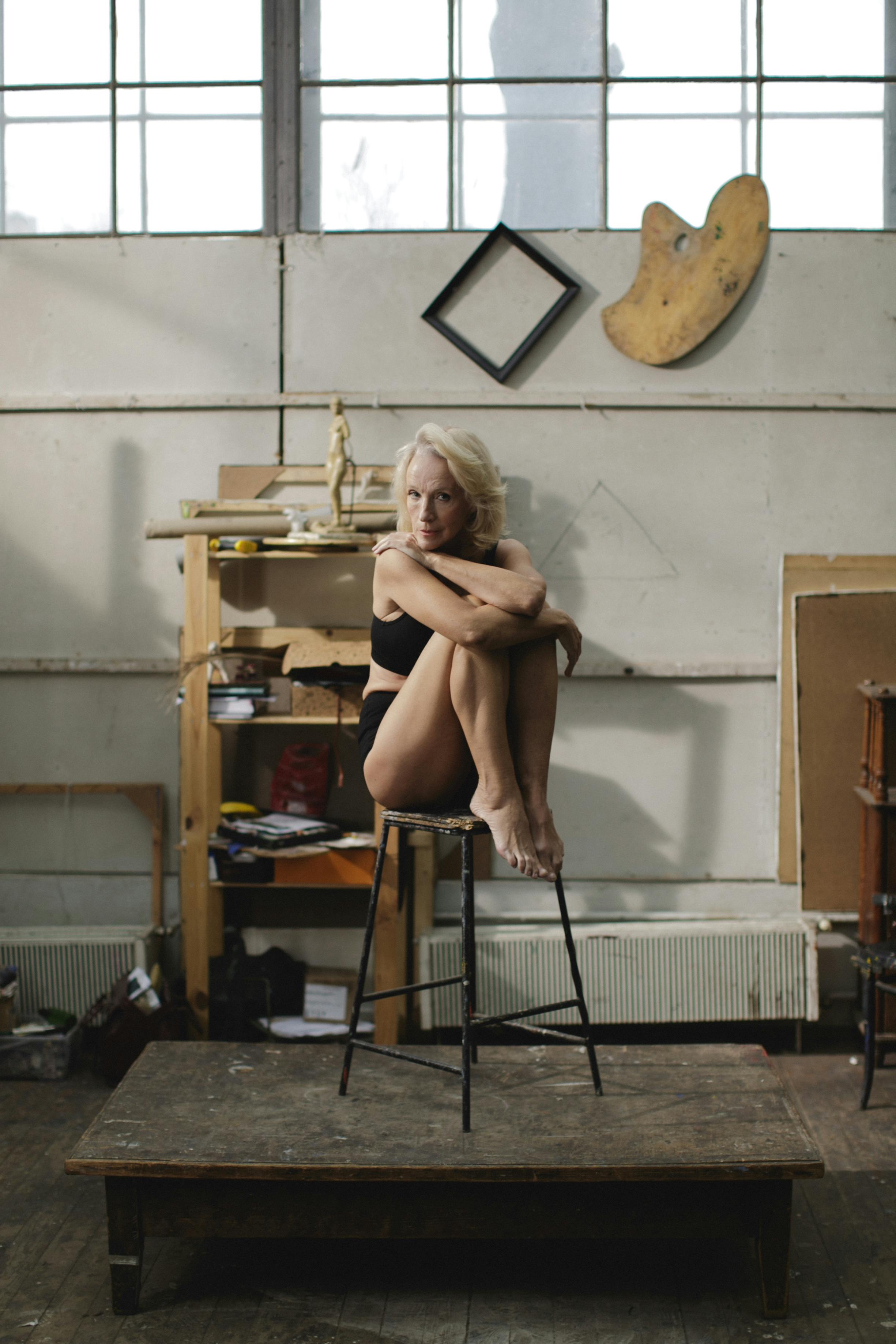 woman in black underwear sitting on s bar stool