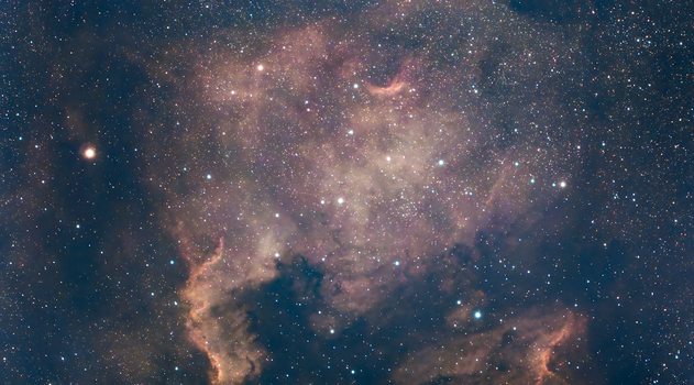 Captivating view of a nebula surrounded by stars in the deep Milky Way sky.