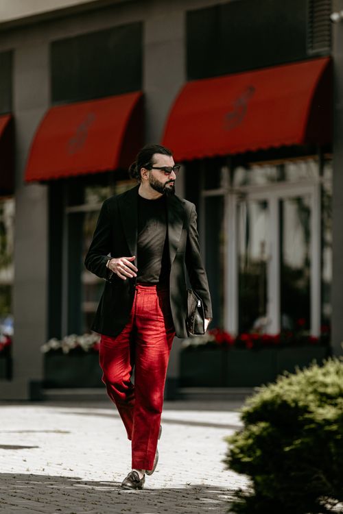 Free Stylish man in red pants and black blazer walking downtown Baku, Azerbaijan. Stock Photo