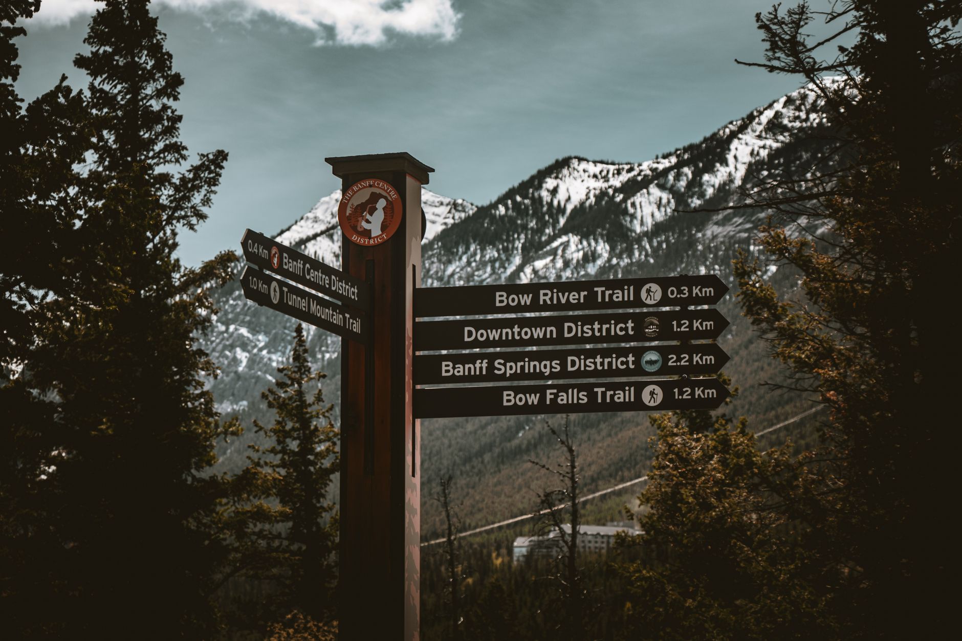 Trail signs guide hikers through Banff National Park's stunning mountain landscape in Alberta, Canada.