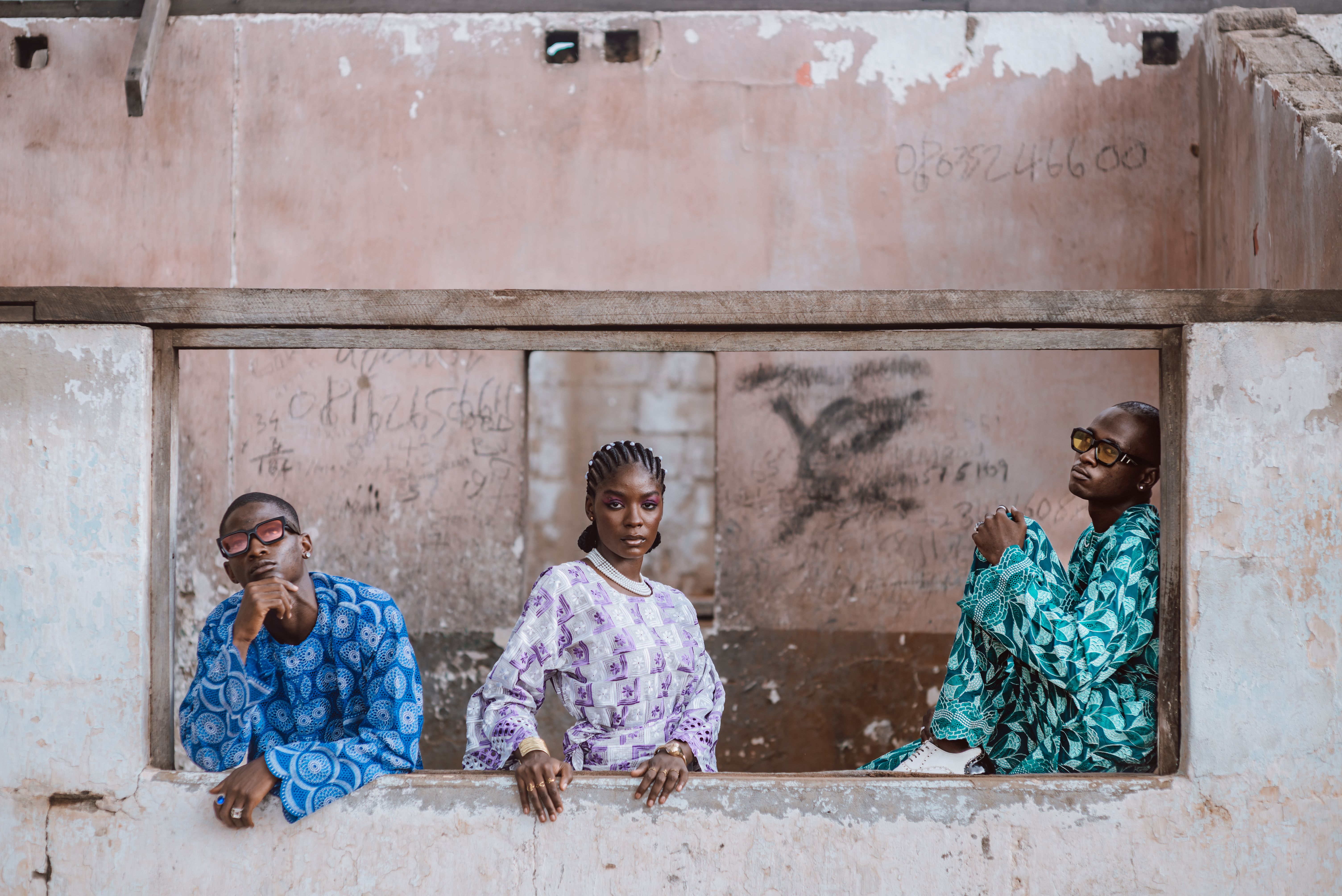 Three stylish individuals in urban setting, Togo