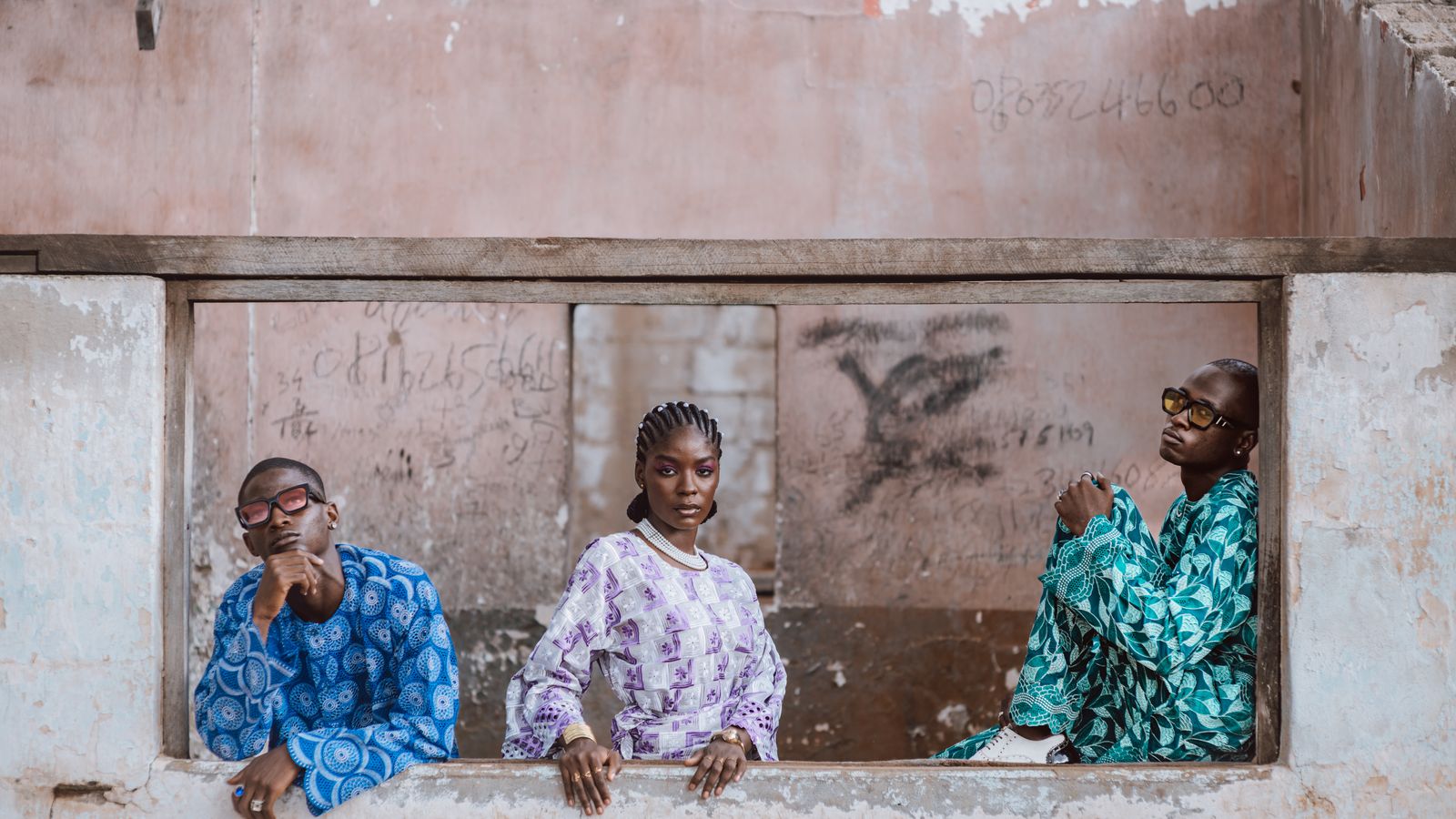 Three stylish individuals in urban setting, Togo