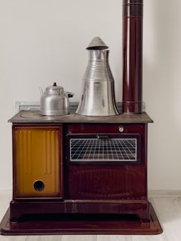 A classic Turkish stove with metal kettle and samovar, perfect for rustic decor or cultural themes.