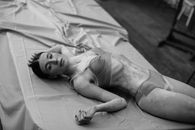 Woman in White Tank Top Lying on Bed