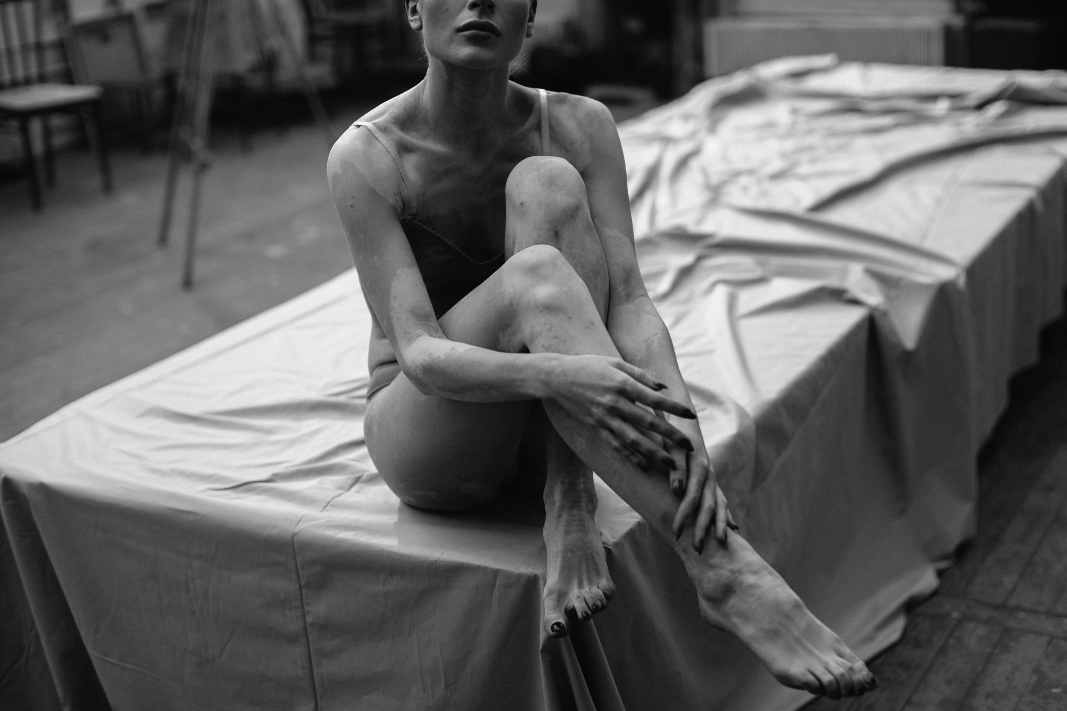 topless woman sitting on bed