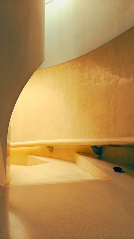 Warm-toned spiral stair in a plaster shell — photo by Devansh Rajput on Pexels