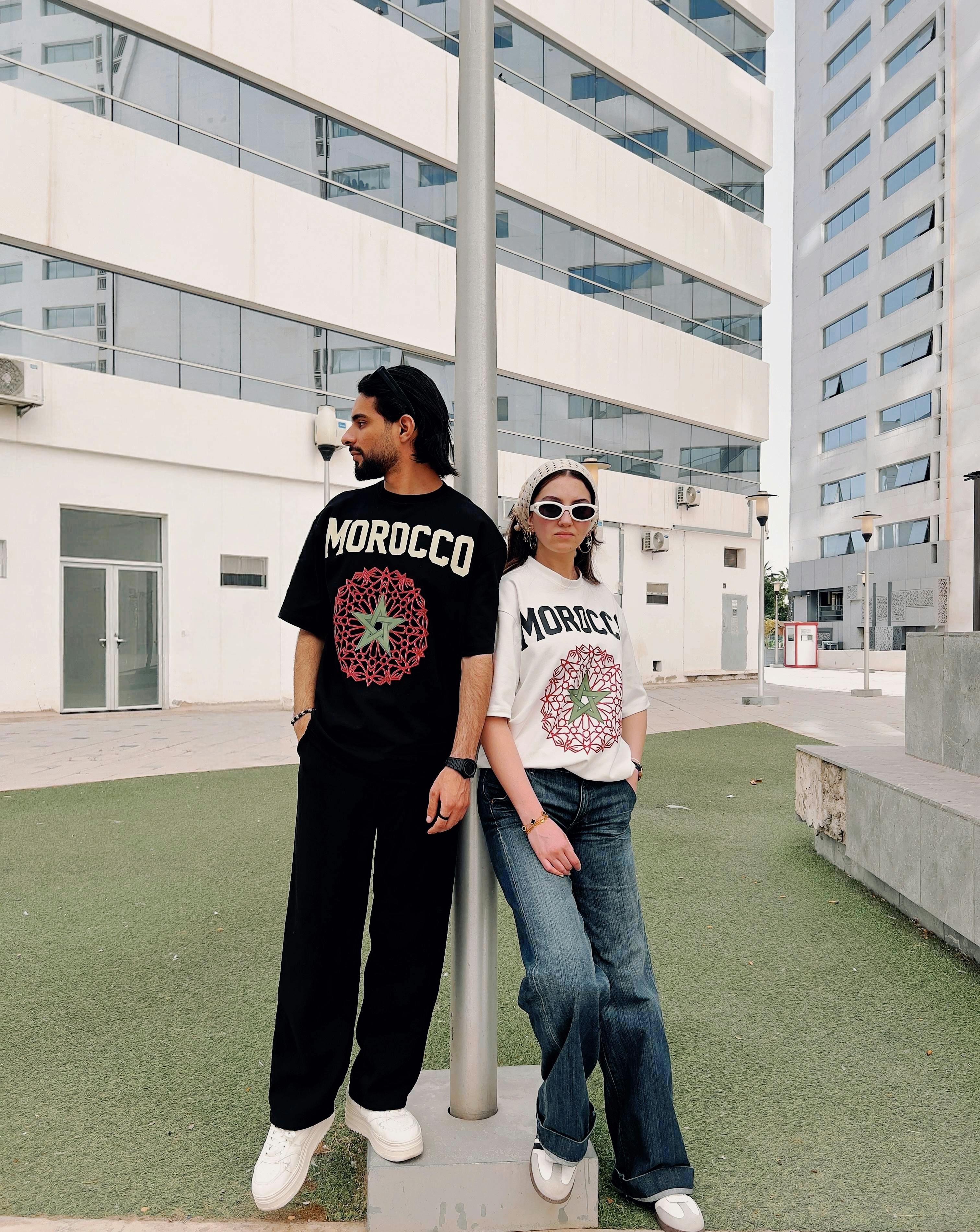 Fashionable duo in urban setting wearing Morocco print t-shirts.