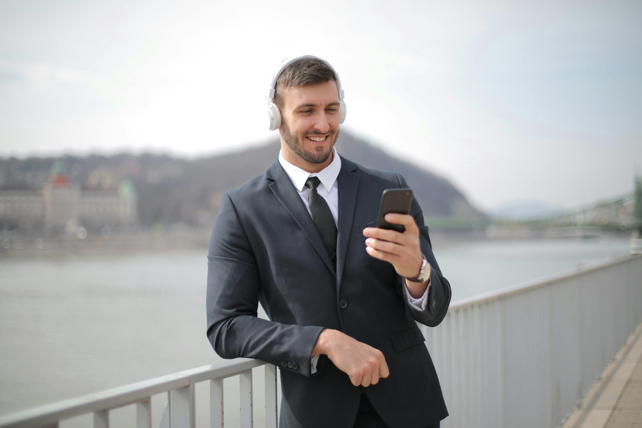 Man in Black Suit Jacket Holding Black Smartphone · Free Stock Photo