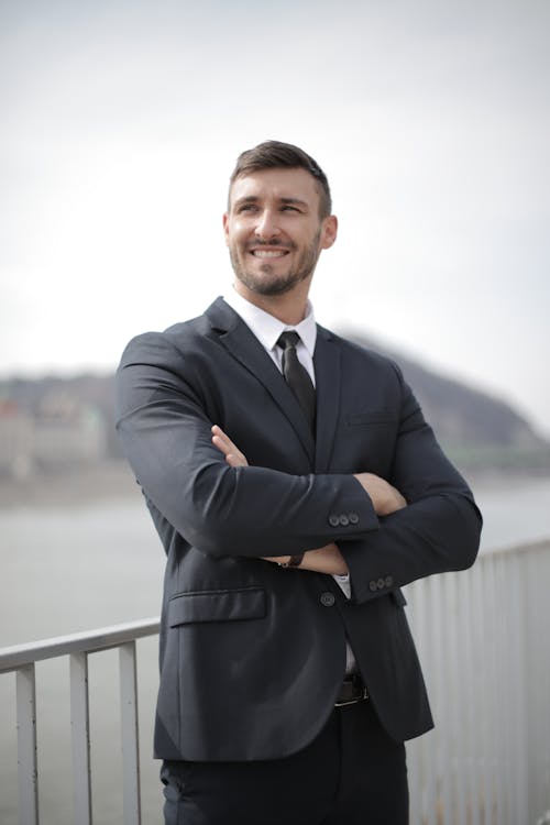 Free Man in Black Suit Jacket Standing Near Railings Stock Photo