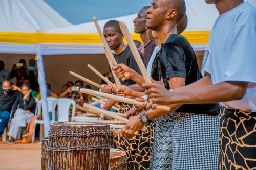 Free Group of musicians performing a vibrant traditional drum routine outdoors. Stock Photo